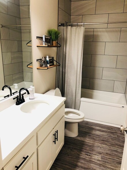 Full bathroom. Beautiful tile work. Shelves, rod and curtain can stay if desired. - 12048 NE 109th St