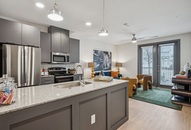 Kitchen and Living Room with Hardwood Floors - Legacy at Veramendi