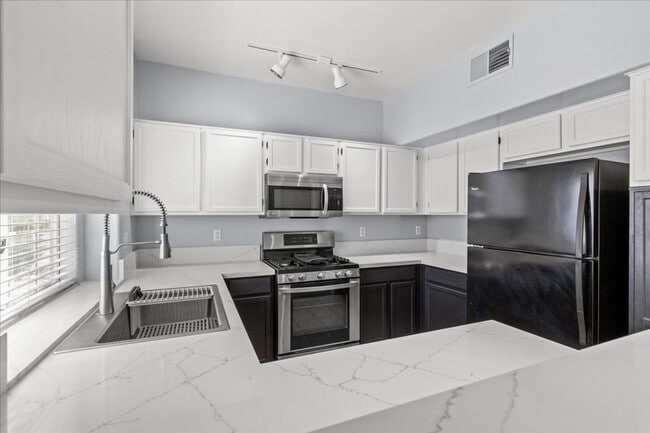 Building Photo - Sleek 2 Bedroom Condo with 2 Car Garage Ne...