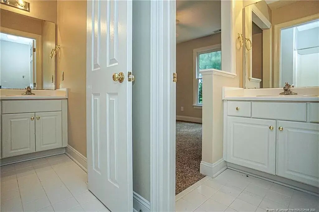Full bath has unique access to bedroom 1 and hallway, each with separate sinks - 1977 Culpepper Ln