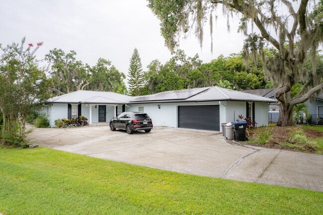 Building Photo - Lake Jessamine Luxury: Solar-Powered Waterfront Retreat on 1.14 Acres with Dock & Boathouse