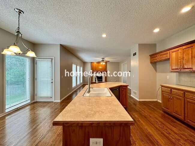 Building Photo - Beautiful Four-Bedroom Home with Three Car Garage, Wood Floors, Finished Basement and a Fenced Ya...