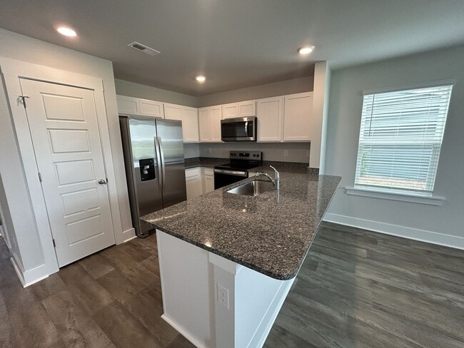 Building Photo - Welcome to this brand new end unit townhome that combines modern convenience with style and charm...
