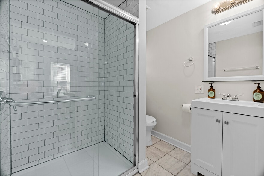 Bathroom with shower stall, electric water heater provides quick hot water on demand. - 2338 W 18th Pl