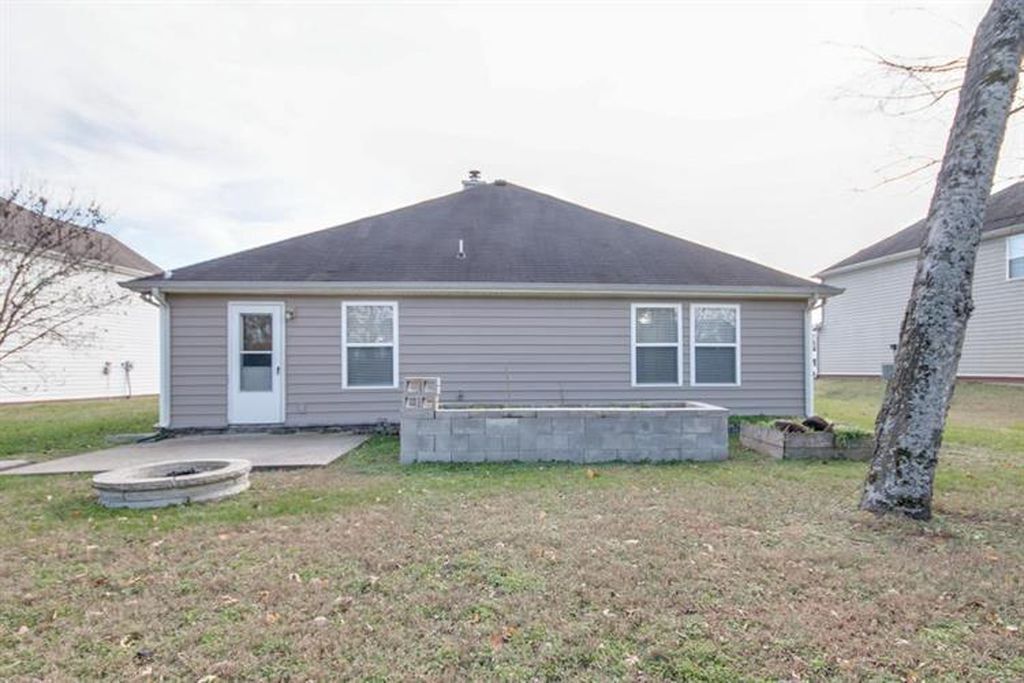 Backyard is Private with a Treeline and Fields Behind the House - 5448 Middlebury Dr