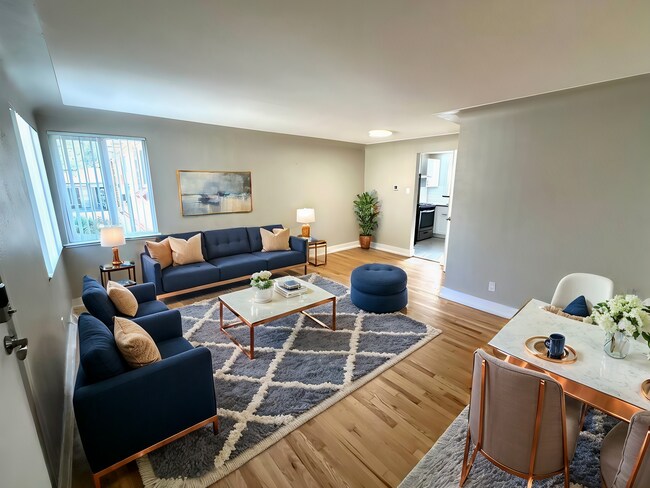 Experience luxury and comfort in this chic living and dining space. - Flats at 16th