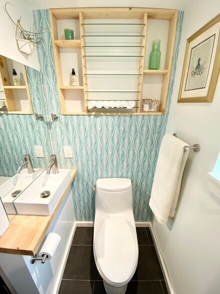 Bathroom with soft-close pocket door and hand wash basin. - 4045 54th Ave SW