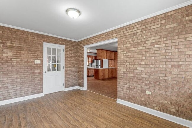 Building Photo - Large Brick Ranch, New Wood Like Flooring Throughout, Just Painted, LR, Den, Sun Room, Carport!