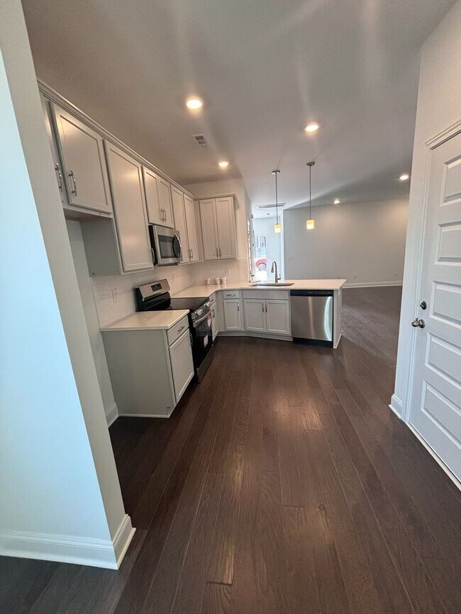 Building Photo - **BE THE LUCKY ONE TO LIVE IN THIS 2024-BUILT END-UNIT TOWNHOME IN A RESORT-STYLE COMMUNITY**