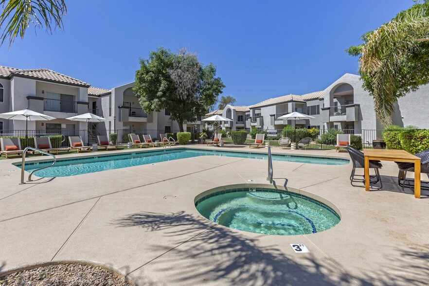 Dive into relaxation in our pool oasis with a hot tub and shaded lounging area - Boulders at Lookout Mountain Apartment Homes