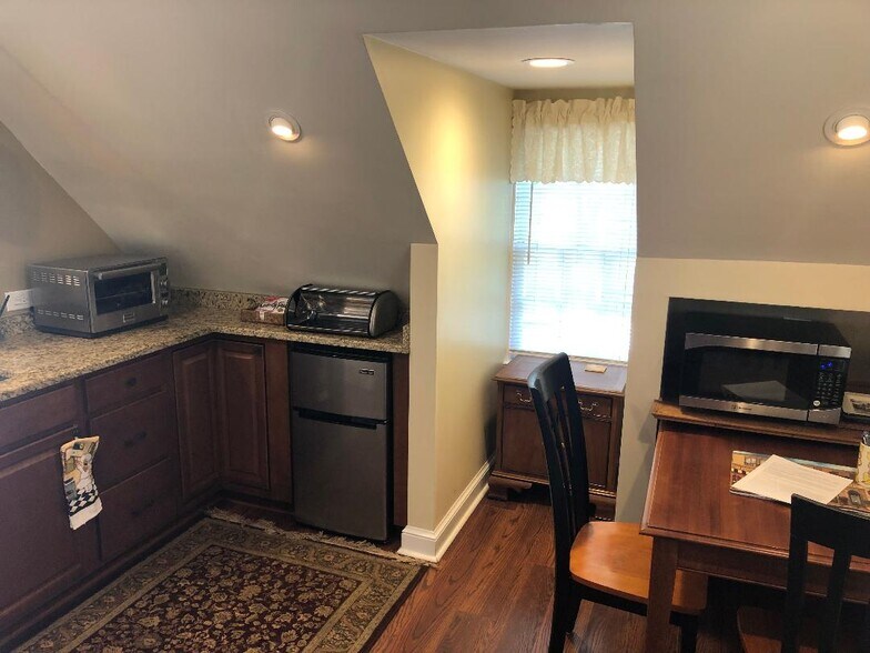 Kitchen area with mini fridge and small appliances. - 5804 Searl Ter