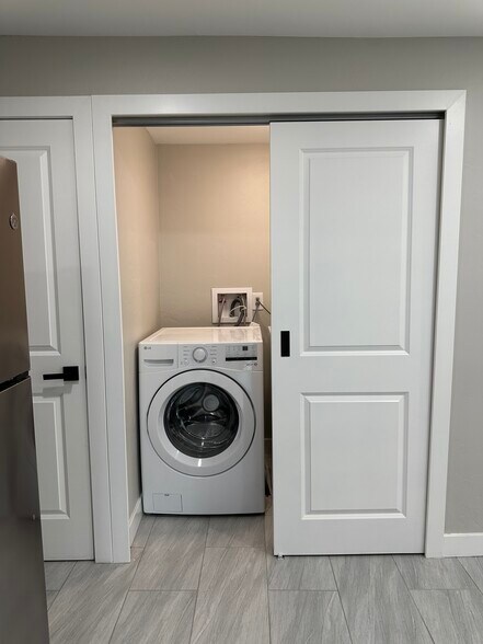 Inside laundry closet with brand new front-loading washer... - 1331 W Speedway Blvd