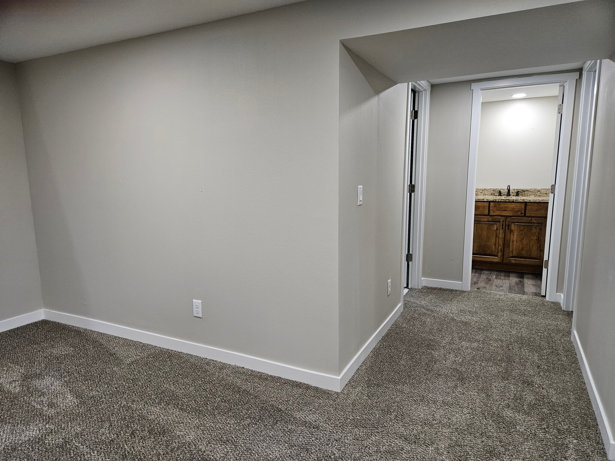 Lower level family room, hall, bathroom - 413 SW Westlawn Dr