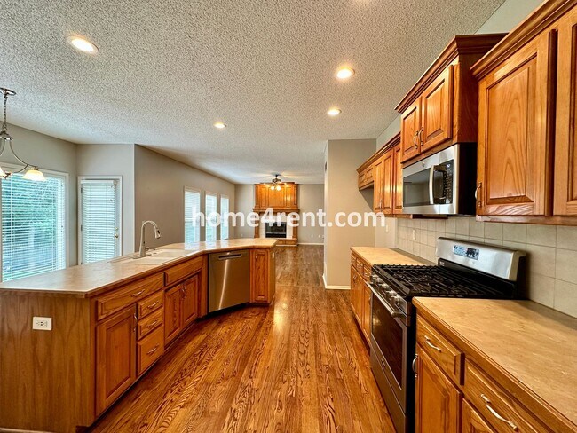 Building Photo - Beautiful Four-Bedroom Home with Three Car Garage, Wood Floors, Finished Basement and a Fenced Ya...
