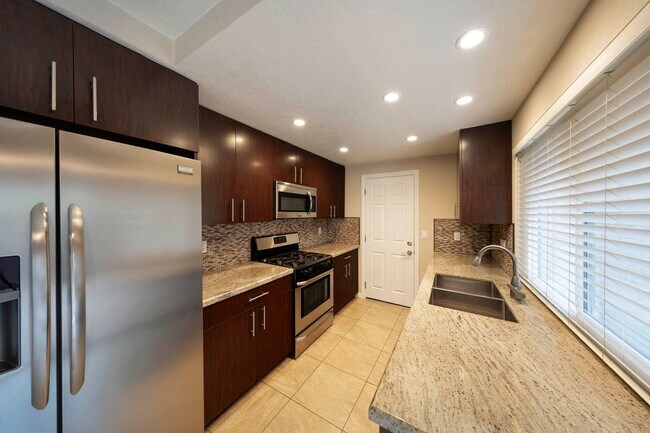 Building Photo - Fully renovated 2 bedroom 2 car garage Townhome