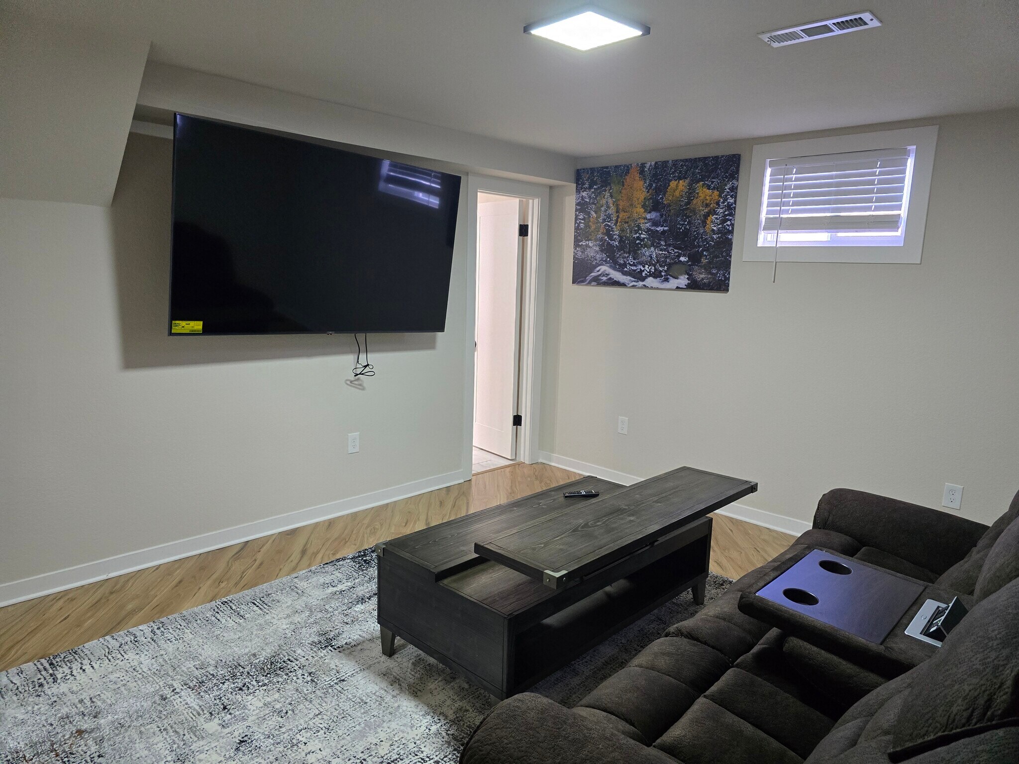 Downstairs living room with adjustable couch and coffee table. - 902 S Zephyr Ct
