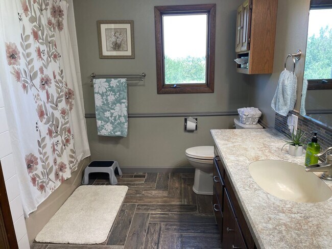 Building Photo - Spacious, four-bedroom, two-bathroom, coun...