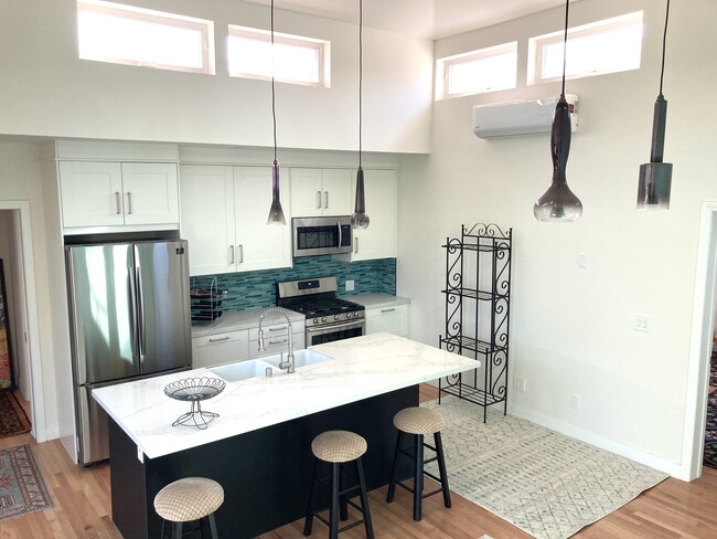 Kitchen w/ Murano glass pendant lights. - 1735 Midvale Ave