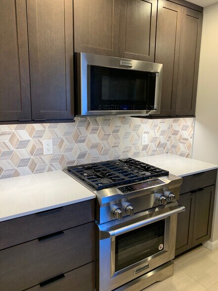 renovated kitchen with Kitchen Aid Pro dual fuel range - 5536 Village Dr