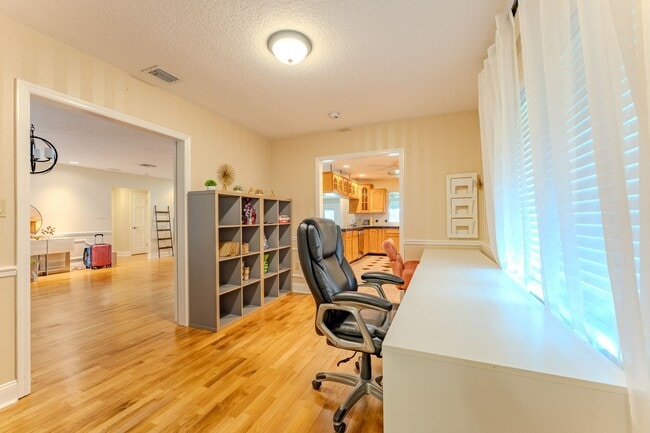 Building Photo - Lake Jessamine Luxury: Solar-Powered Waterfront Retreat on 1.14 Acres with Dock & Boathouse