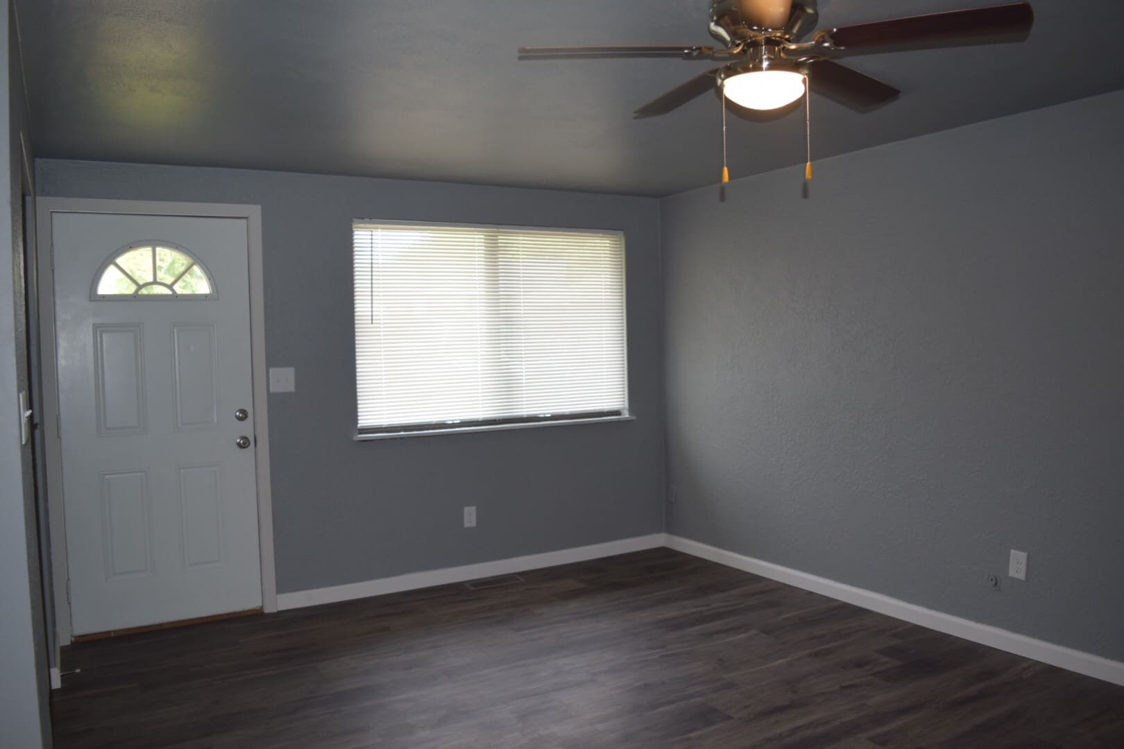 Spacious living room with large windows letting in natural light. - 108 Wood Ct