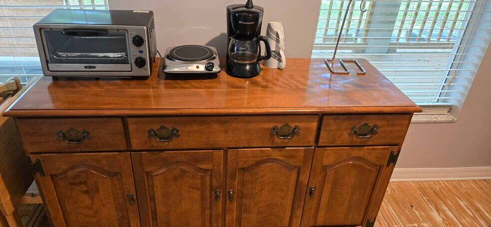 buffet with dishes, burner, toaster oven, coffe pot - 6542 Sherry Ln