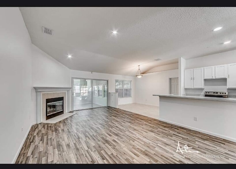 Living room with fireplace and sundeck porch - 11160 Apple Blossom Trl W