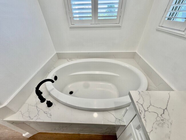 Building Photo - Beautifully Remodel Townhouse with AC & Two Car Garage!