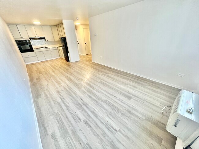 Experience open-concept living with this stylish kitchen and living room setup, perfect for modern lifestyles. - The Sloan