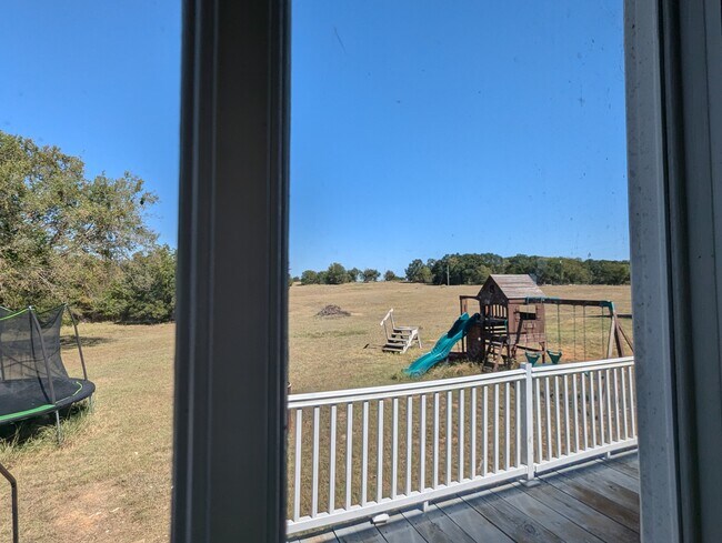 Back Door looking Right, yes playground can remain if asked for. - 179 Davis Rd