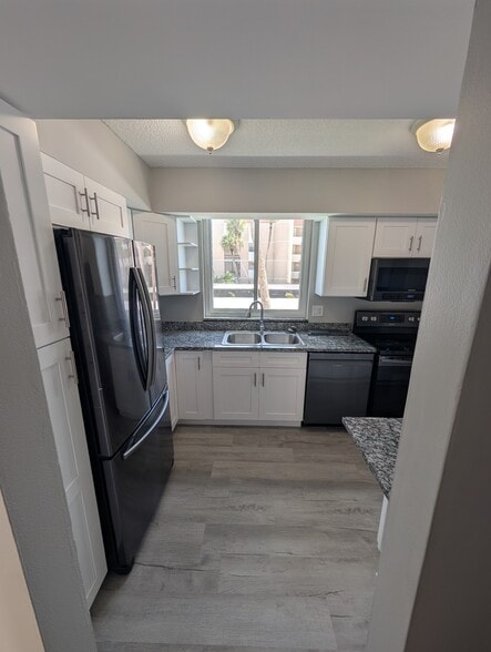 Kitchen with all new cabinets and flooring - 3462 NE Causeway Blvd