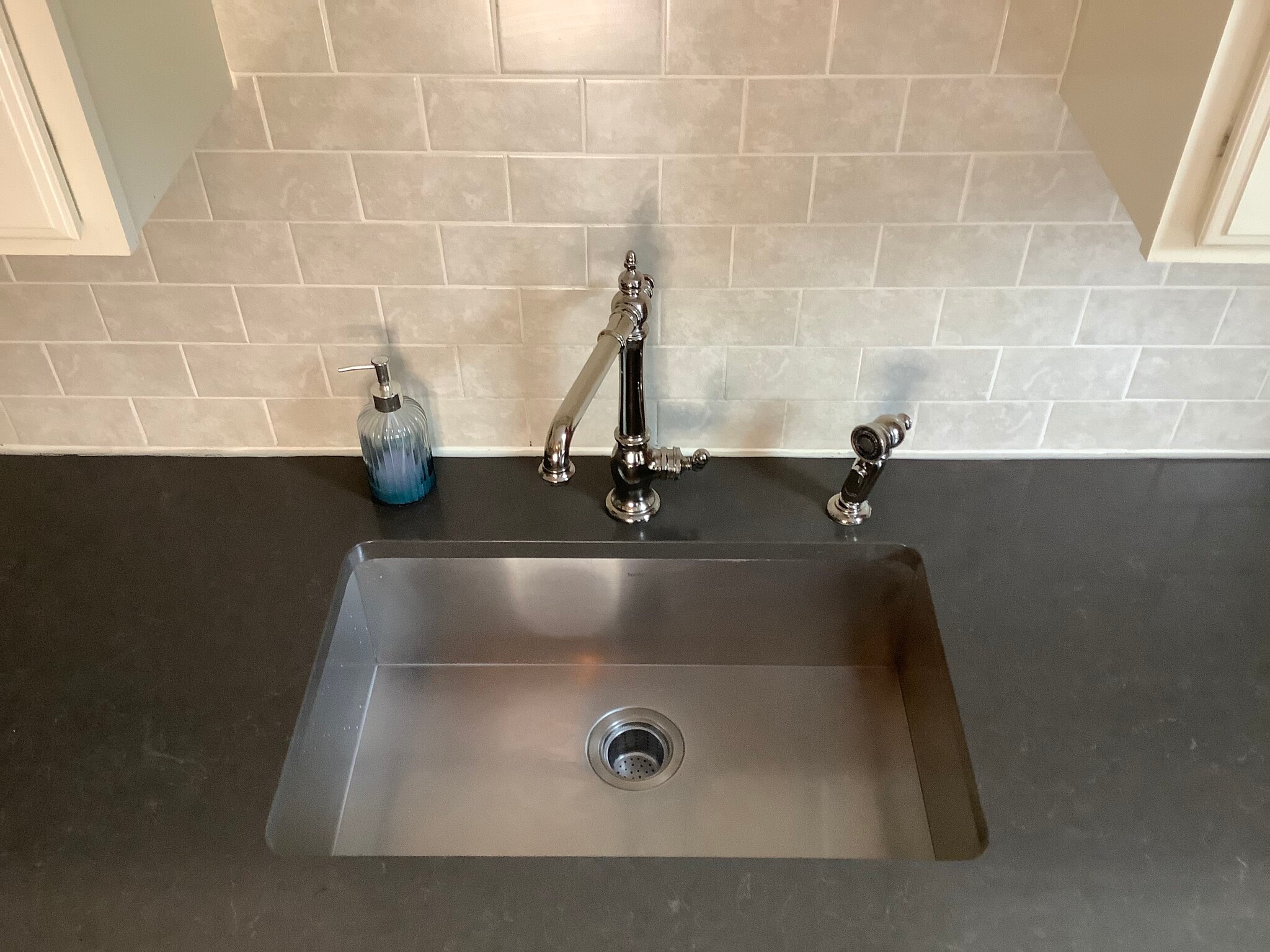 The stainless steel under mount sink is 9” deep. - 9 Jay St