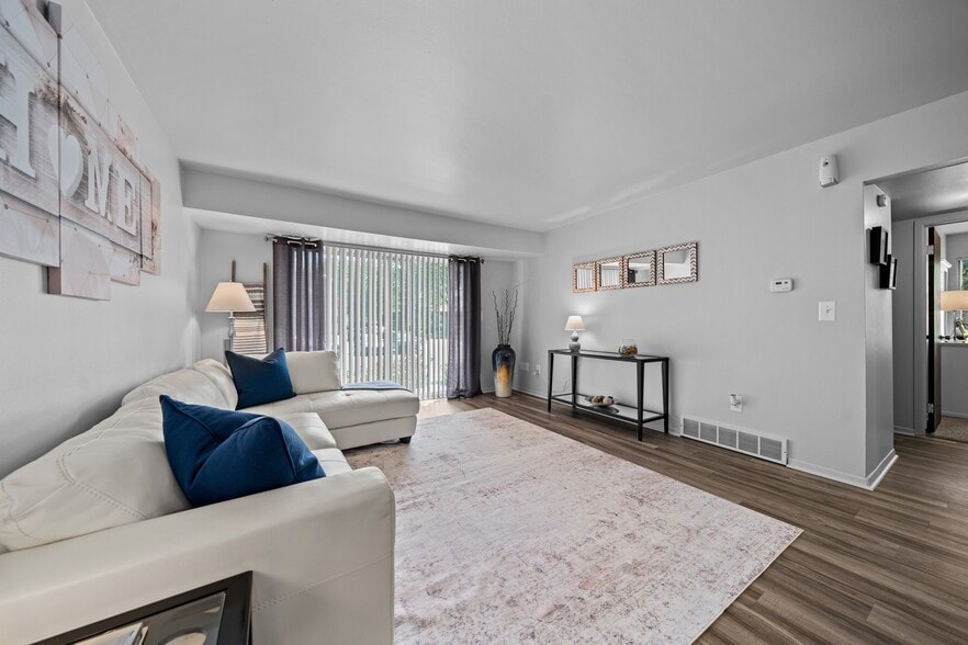 Spacious living room with natural light at Westwood Village Apartments in Westland, MI - Westwood Village Apartments