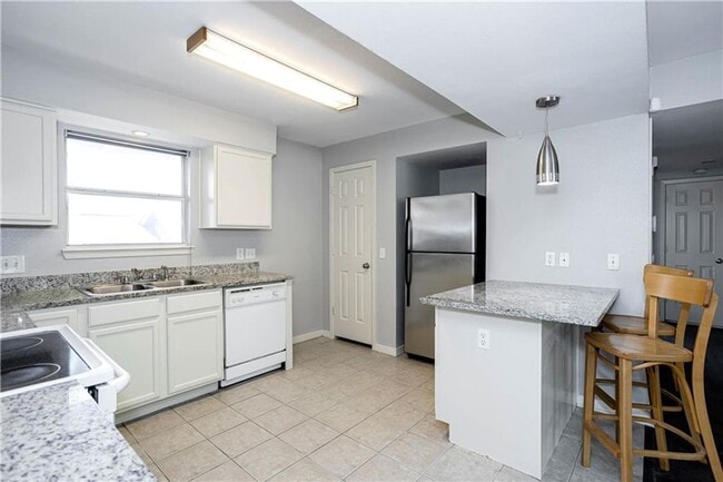 Building Photo - Stunning Renovation - New Hardwood flooring, tile in Kitchen. Granite countertops, breakfast bar