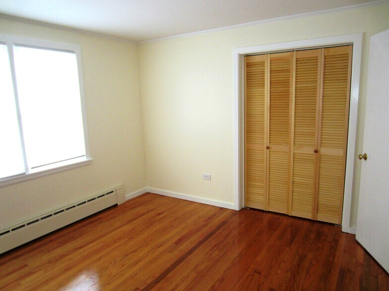 Bedroom 1 with closet and hardwood floors - 30 Fairfield Ave