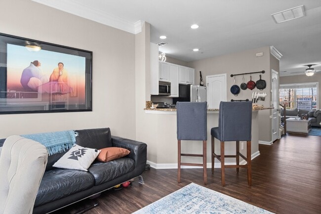 Building Photo - This inviting two-level townhome offers comfort and style, featuring gleaming hardwood floors on ...