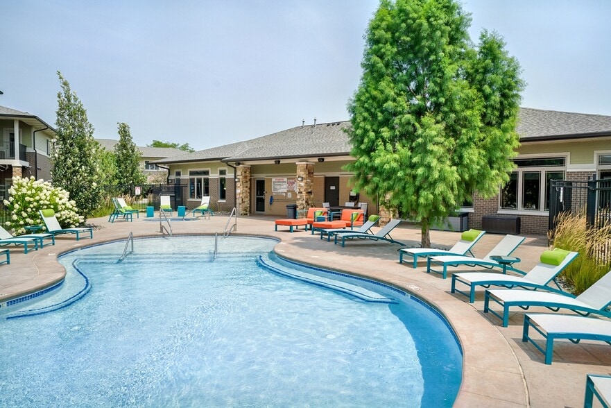 Our resort-style pool with lounge seating is the perfect place for relaxation. - The Villas at Wilderness Ridge