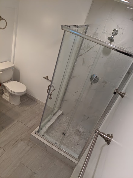 Marble-tiled walk-in shower - 6534 Peterson Ave