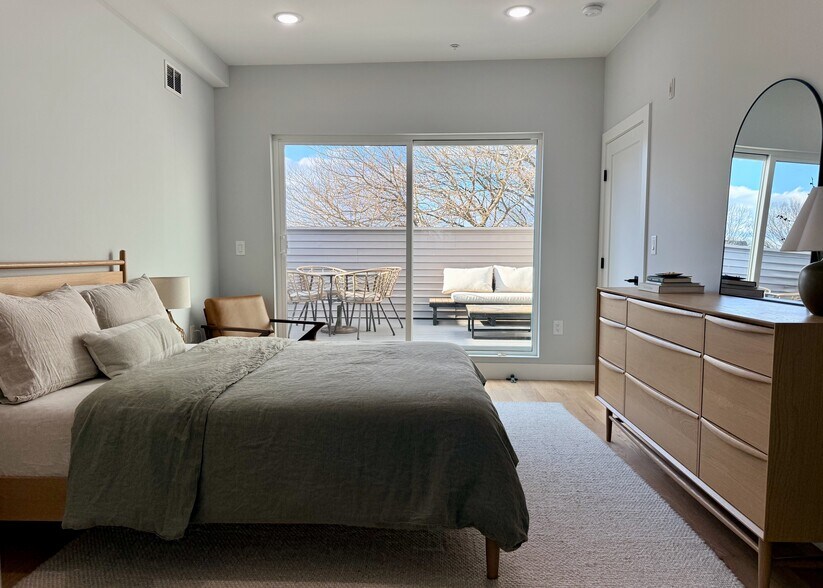 Bright Primary Bedroom with Seamless Access to Rooftop Deck via Sliding Door - 443 Bergen Ave
