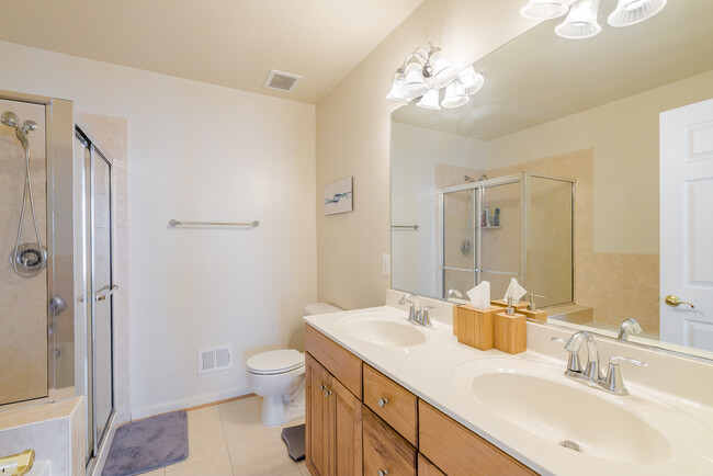 Master bathroom, with standing shower, bathtub and two sinks, lots of storage below countertops - 22785 Settlers Trail Terrace