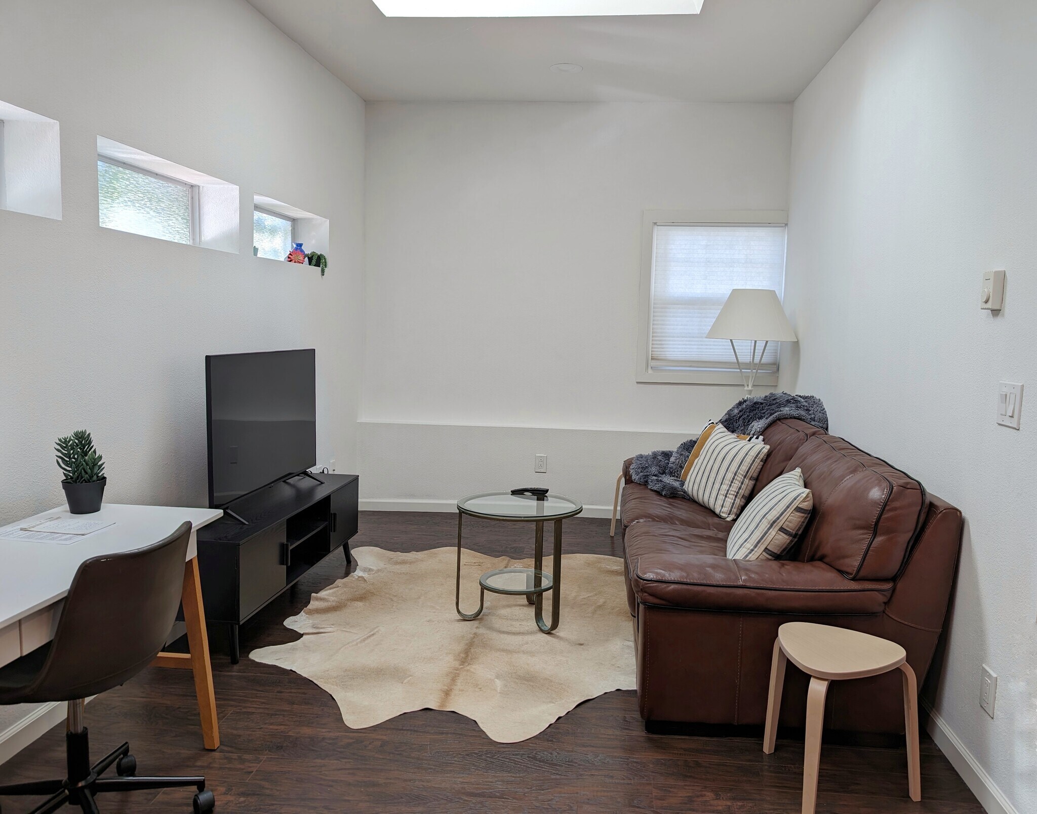 Living room with skylights and workspace - 26 Saddle Brook Ct