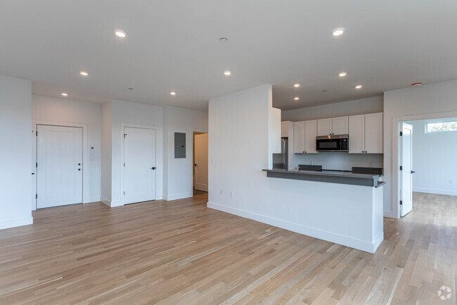 Unit 402 living room and kitchen. - The Residence at 581 Salem St