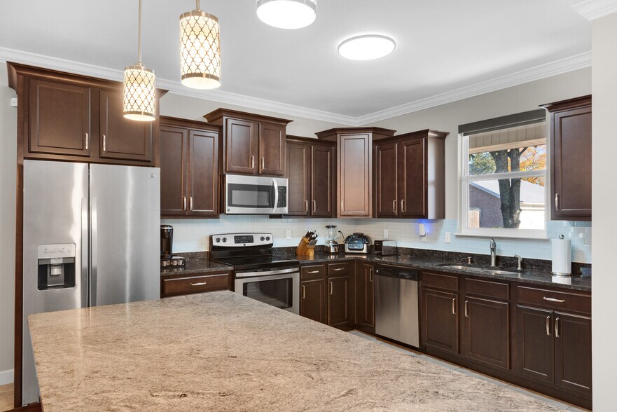 Kitchen has cooking appliances, cookware, utensils, and dishware - 28 Snook Rd