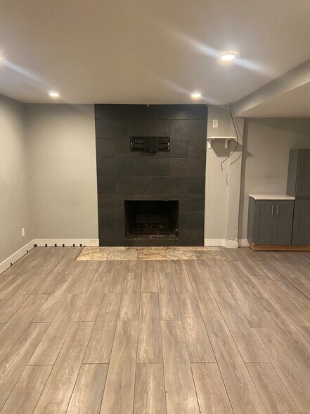 Living Room- fireplace, TV mount, storage, laminate flooring - 3901 N Kiska St