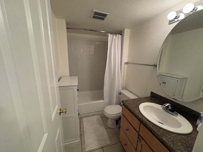 Building Photo - Bright, Modern 1BR Near Hospitals, SU & Transit in secure building with garage parking and a Walk...