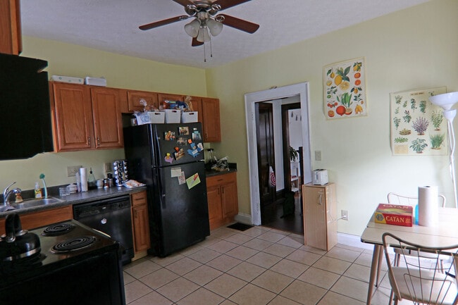 View of kitchen from rear door leading to parking lot. Plenty of cabinet space. - 372 E Oakland Ave