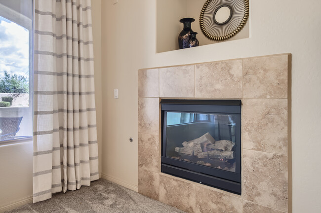 Living room fireplace; cozy & warm for cooler nights - 19475 N Grayhawk Dr