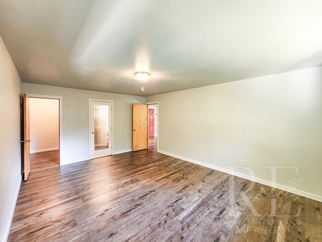 Building Photo - Vaulted Ceilings, Unique Designer Kitchen & Expansive Half-Acre Setting with Flexible Living Spaces