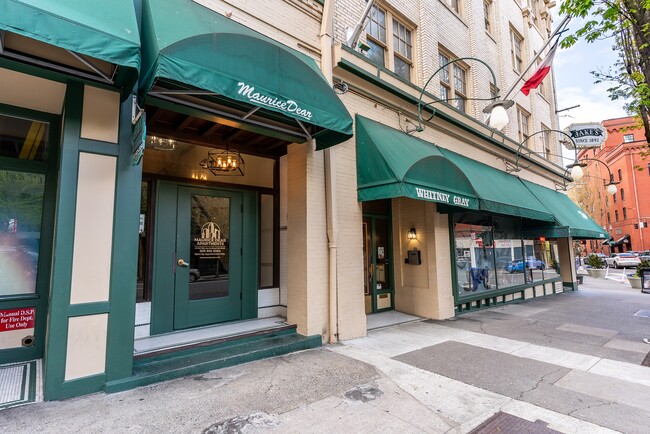 Street view of front of property with green awning - Whitney Gray