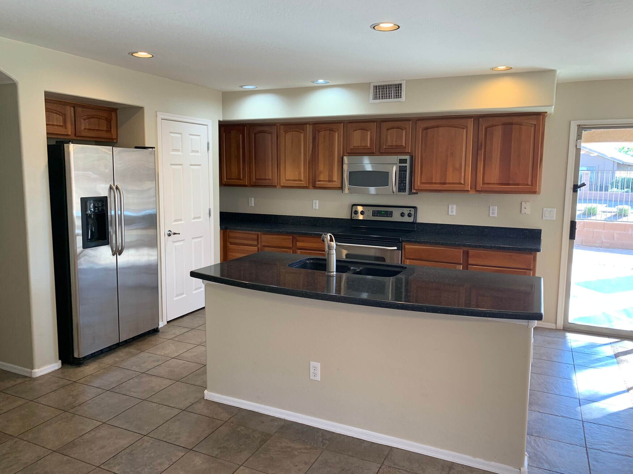 Spacious 4-bedroom, 2-bath home with soaring ceilings, gourmet kitchen, and a heated self-cleaning p - 16426 N 152nd Ln